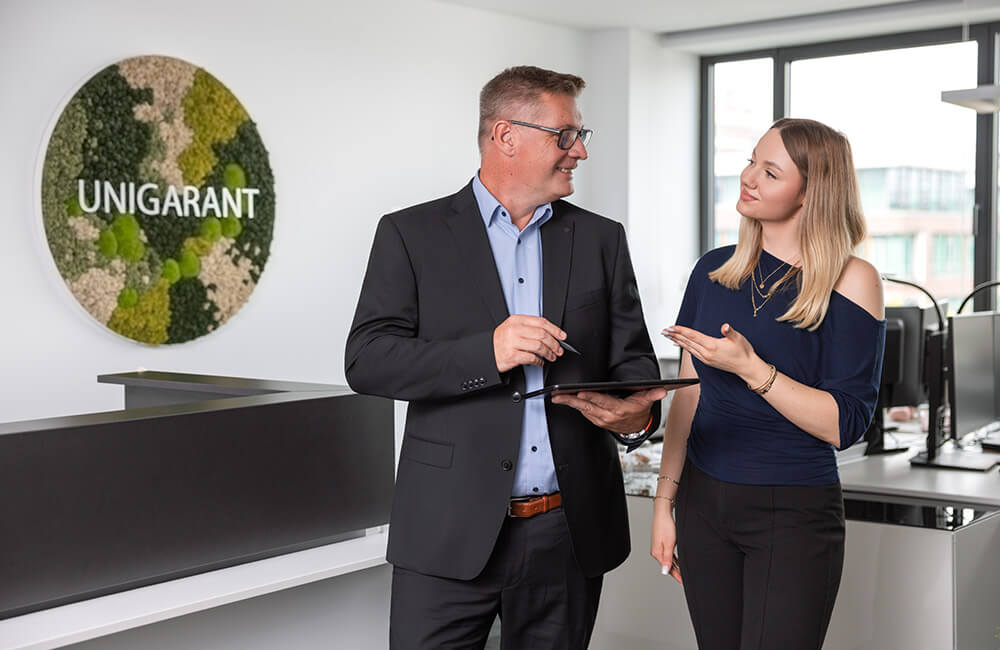 Eine Mitarbeiterin holt sich Rat bei einem der Partner.